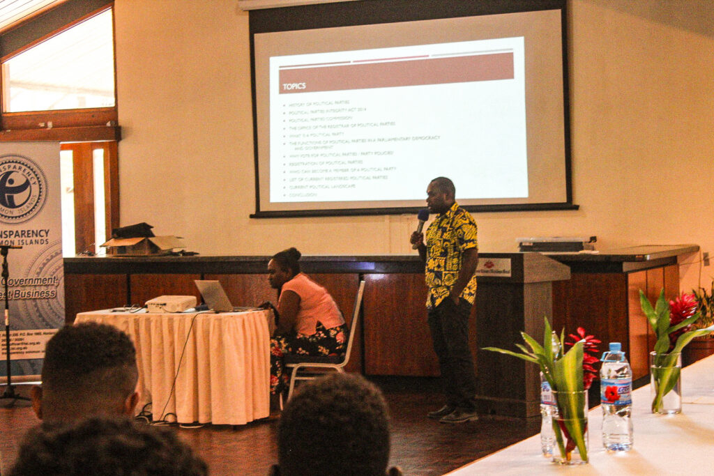 Presenter explaining political party integrity topics during a training session.