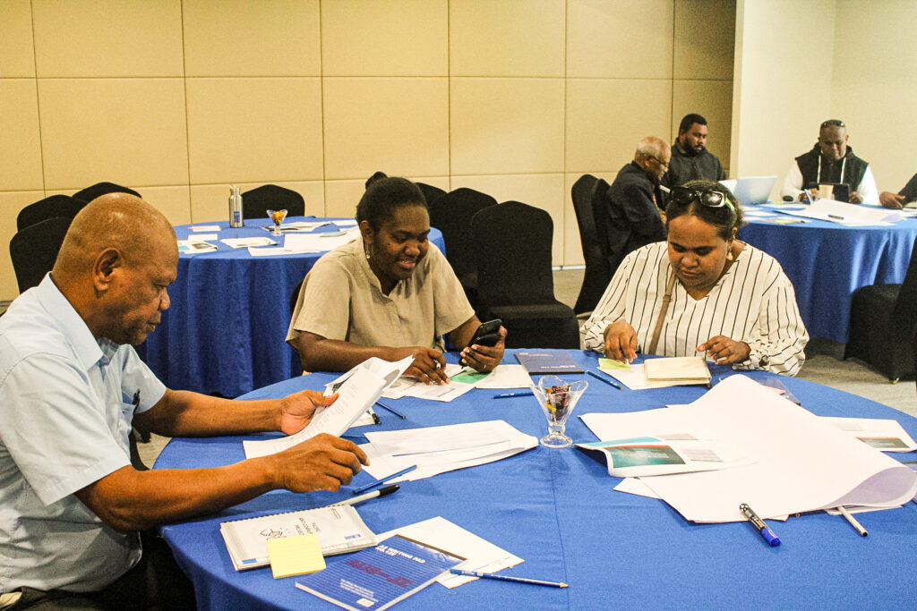 Participants reviewing civic education materials during a workshop.