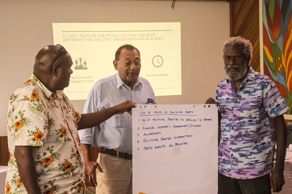 Community representatives presenting discussion notes about political party integrity.
